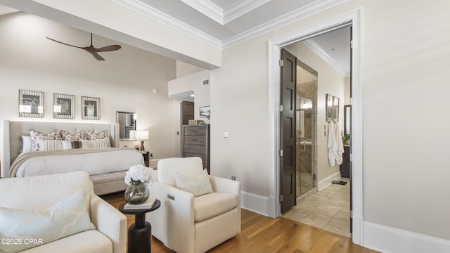 bedroom featuring crown molding, connected bathroom, ceiling fan, and light wood-type flooring