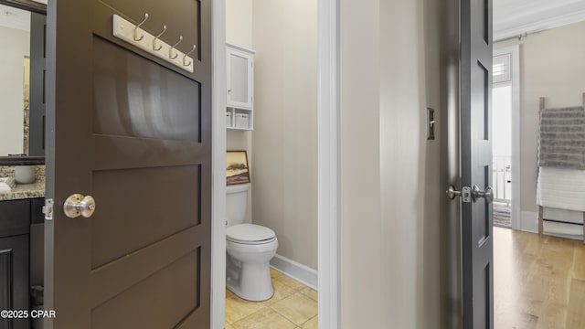 bathroom with vanity, tile patterned flooring, and toilet