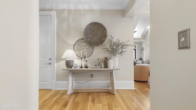 hallway featuring ornamental molding and hardwood / wood-style floors