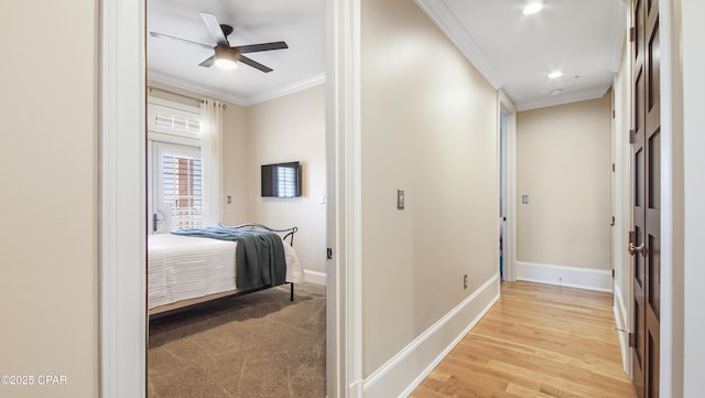 corridor featuring crown molding and light wood-type flooring