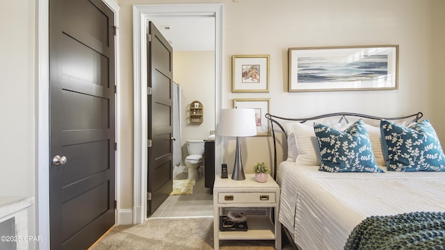 carpeted bedroom with connected bathroom