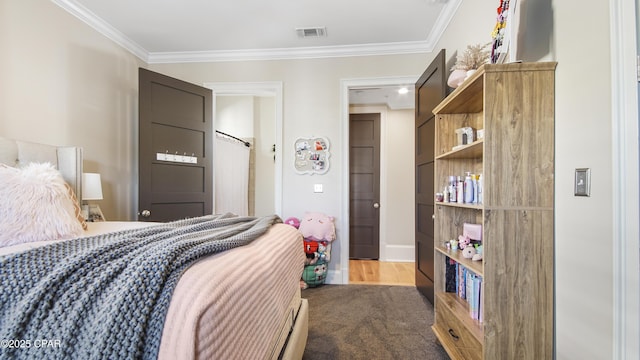 bedroom featuring crown molding and carpet floors