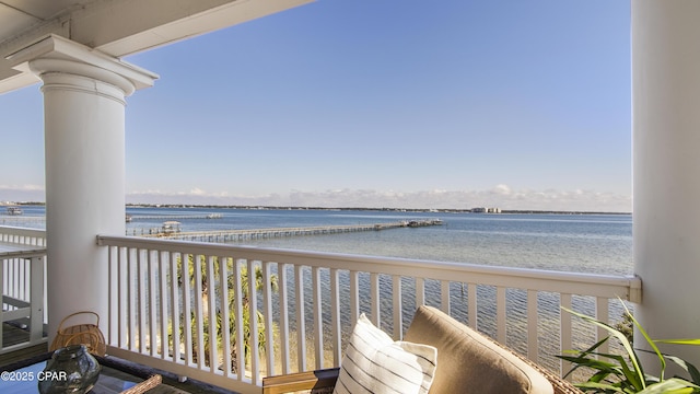 balcony featuring a water view and a beach view