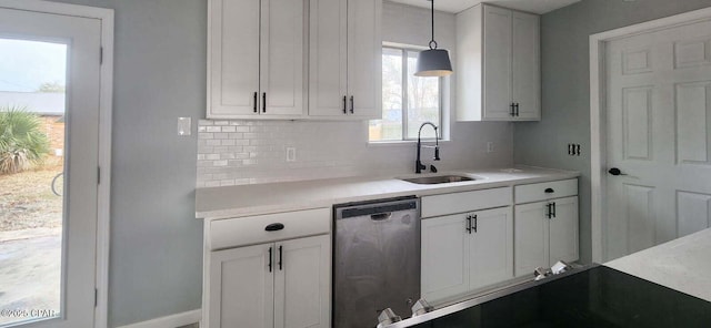 kitchen with sink, white cabinetry, backsplash, decorative light fixtures, and stainless steel dishwasher