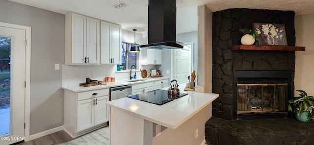 kitchen with visible vents, dishwasher, island exhaust hood, black electric cooktop, and a sink