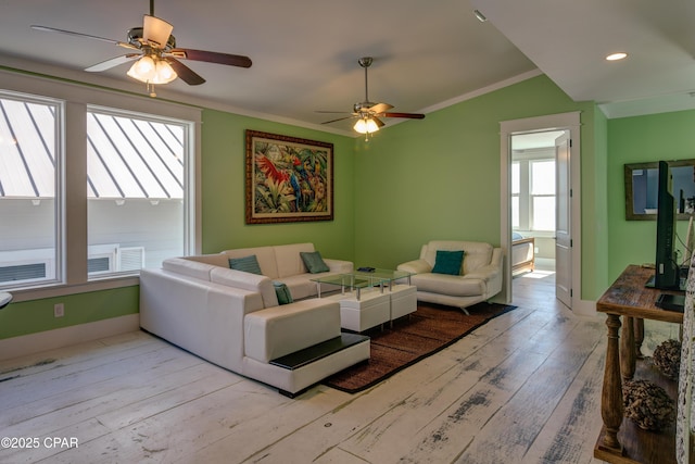 living room featuring ornamental molding, lofted ceiling, ceiling fan, and light wood-type flooring