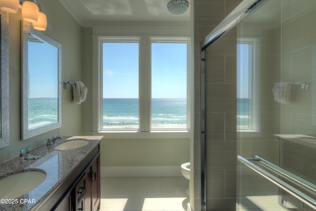 bathroom featuring vanity, an enclosed shower, toilet, a water view, and tile patterned floors