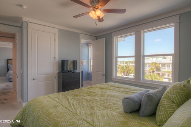 bedroom featuring ornamental molding and ceiling fan