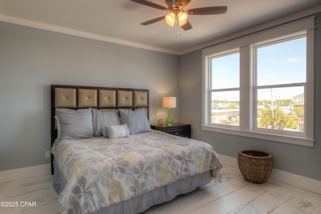 bedroom featuring crown molding, ceiling fan, and multiple windows