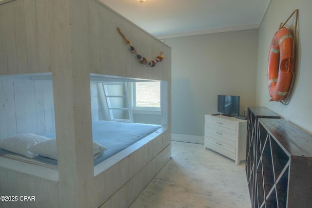 bedroom featuring crown molding and wood walls