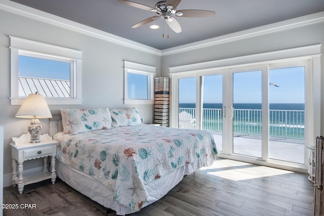 bedroom featuring a water view, ceiling fan, dark wood-type flooring, and access to outside