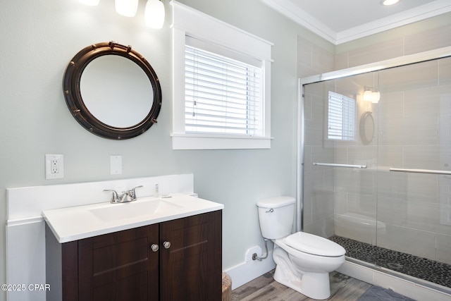 bathroom with a shower with shower door, hardwood / wood-style flooring, vanity, toilet, and crown molding