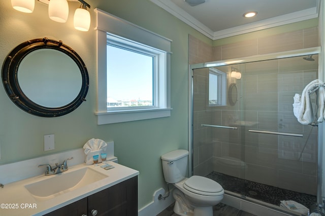 bathroom with vanity, a shower with door, and toilet