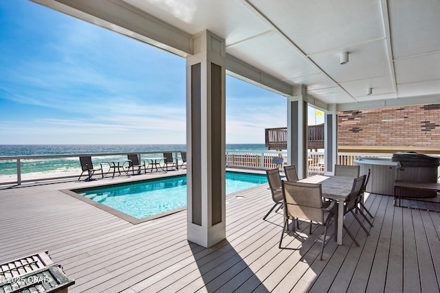 wooden terrace featuring a water view