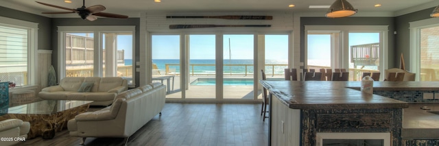 sunroom / solarium featuring a water view