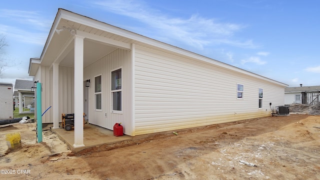 view of side of property featuring central AC