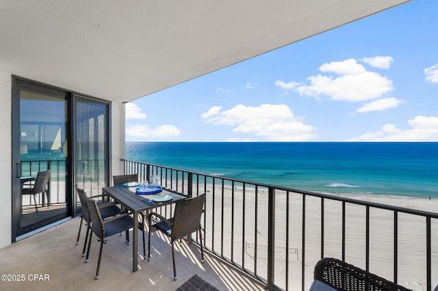 balcony with a water view and a beach view