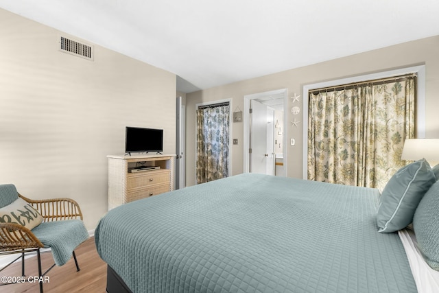 bedroom featuring vaulted ceiling and light hardwood / wood-style floors