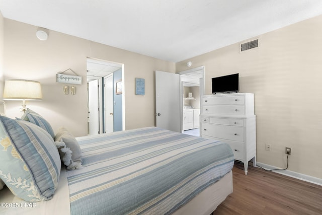 bedroom featuring wood-type flooring and washer and clothes dryer