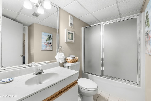 full bathroom with bath / shower combo with glass door, a paneled ceiling, vanity, and toilet