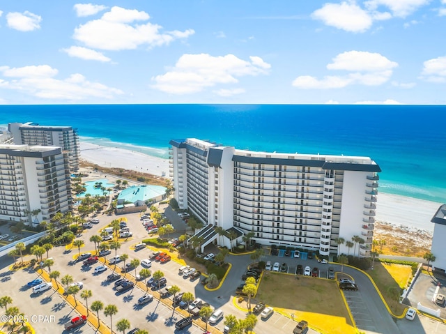 bird's eye view with a water view and a beach view