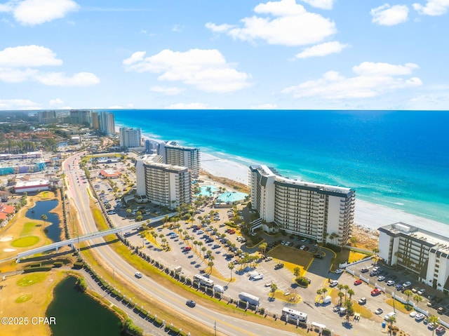 drone / aerial view featuring a water view and a view of the beach