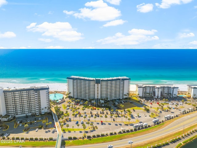 drone / aerial view featuring a beach view and a water view