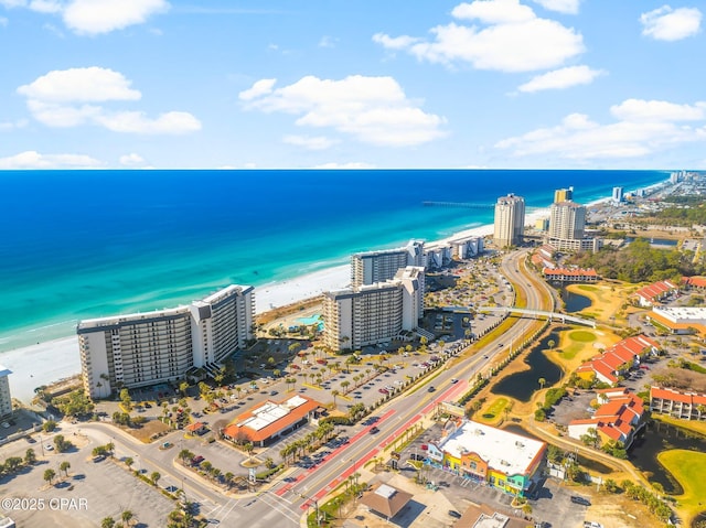 drone / aerial view with a beach view and a water view