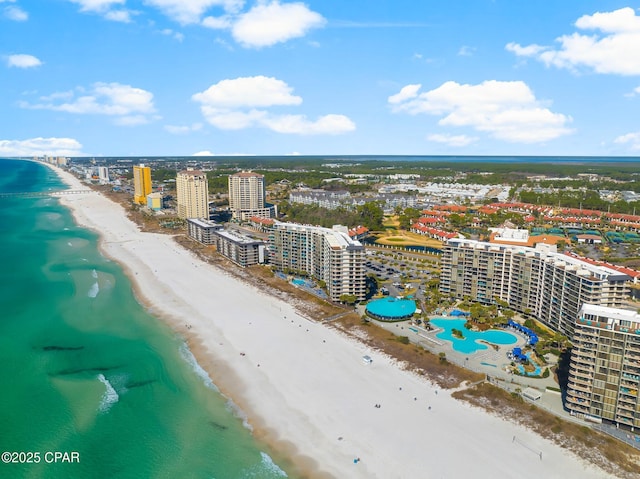 drone / aerial view with a water view and a beach view