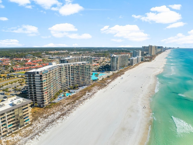 drone / aerial view featuring a water view and a beach view