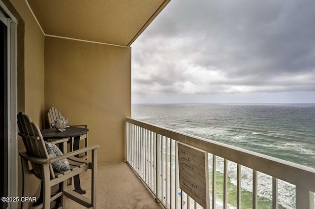 balcony with a beach view and a water view
