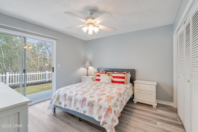 bedroom featuring ceiling fan, a closet, light hardwood / wood-style flooring, and access to outside