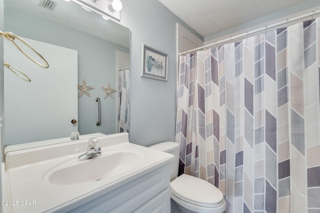 bathroom with vanity, a textured ceiling, a shower with curtain, and toilet