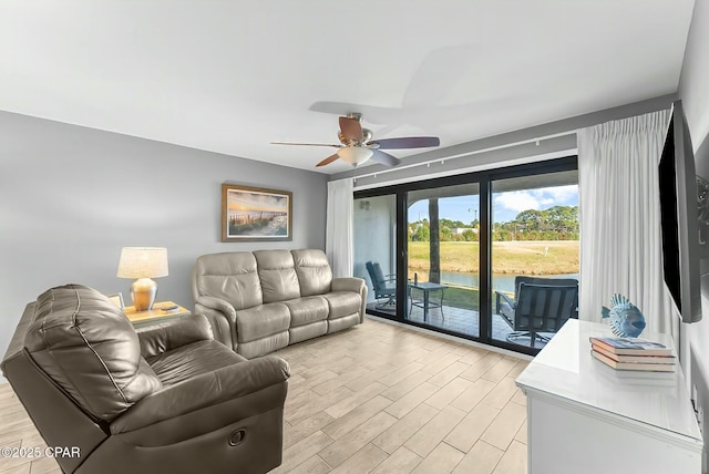 living room with ceiling fan and light hardwood / wood-style flooring