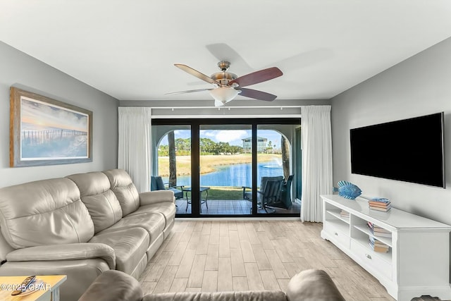 living room with light hardwood / wood-style floors and ceiling fan