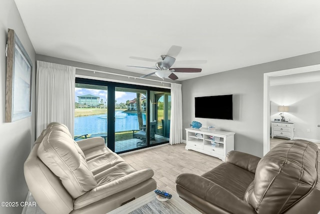 living room with ceiling fan and light hardwood / wood-style floors