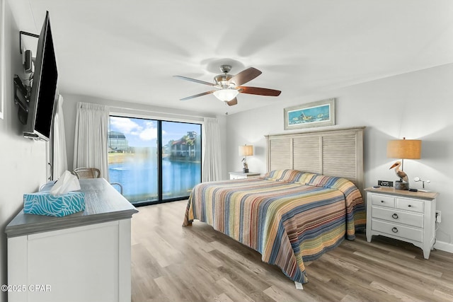 bedroom with access to exterior, ceiling fan, and light hardwood / wood-style flooring