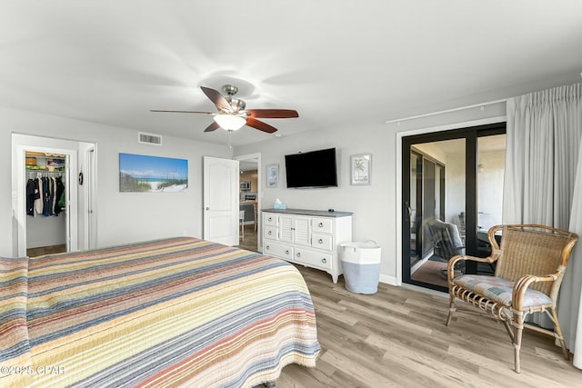 bedroom featuring light hardwood / wood-style flooring, ceiling fan, a spacious closet, access to outside, and a closet