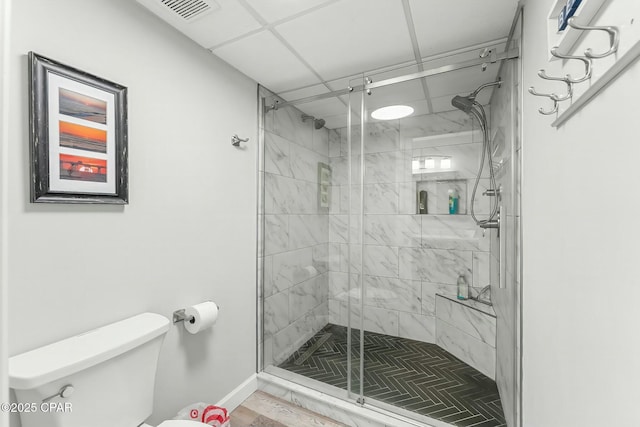 bathroom with toilet and an enclosed shower