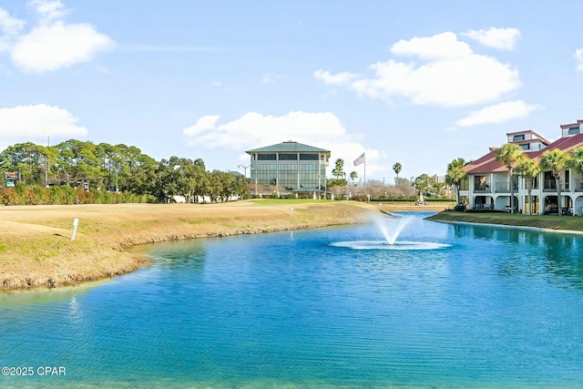 view of swimming pool with a yard and a water view