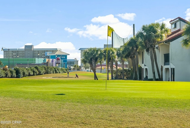 view of property's community with a lawn