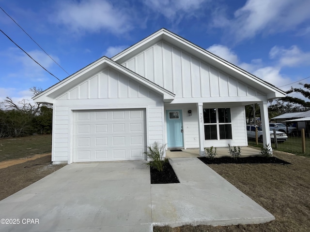 view of front of house featuring board and batten siding, concrete driveway, and a garage