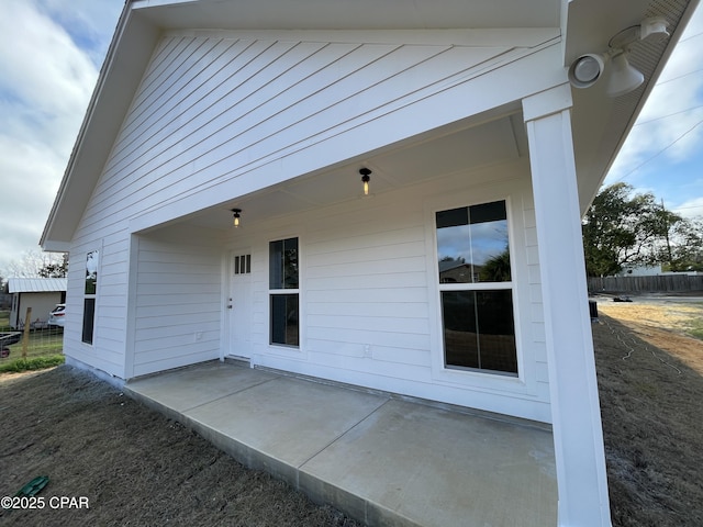 rear view of house featuring a patio area and fence