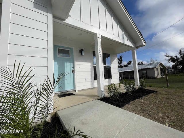 view of exterior entry with board and batten siding