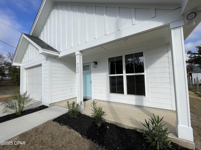 entrance to property featuring covered porch and board and batten siding