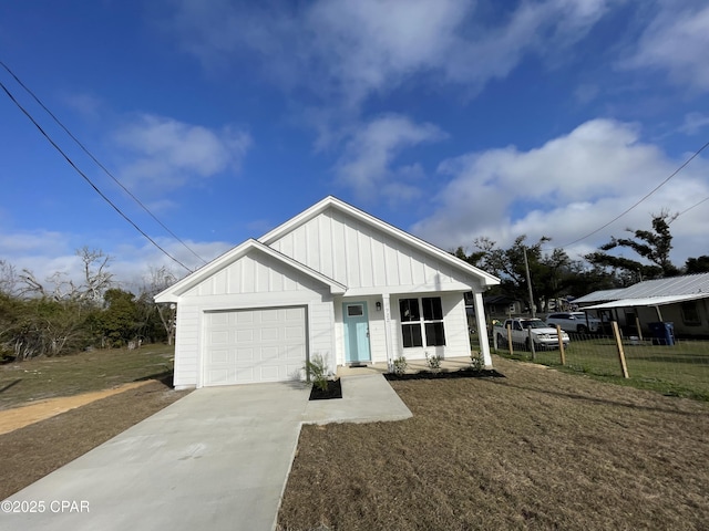 view of front facade featuring driveway, a front lawn, board and batten siding, and an attached garage