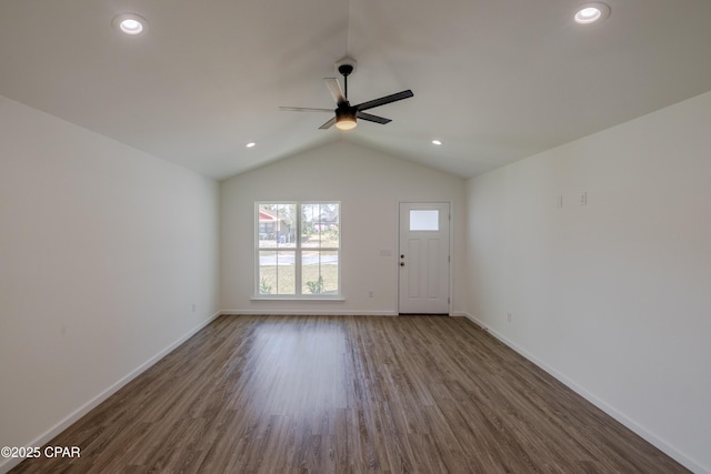 interior space featuring dark wood-style flooring, lofted ceiling, recessed lighting, a ceiling fan, and baseboards