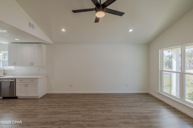 interior space featuring lofted ceiling, a healthy amount of sunlight, and visible vents