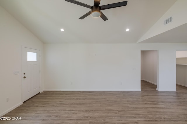 interior space featuring lofted ceiling, light wood finished floors, and visible vents