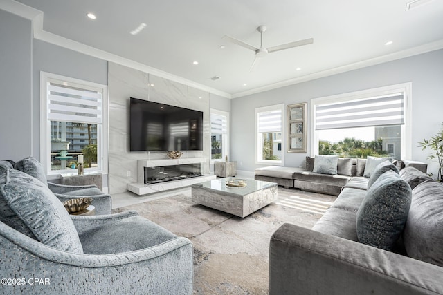living room featuring crown molding, ceiling fan, and a high end fireplace